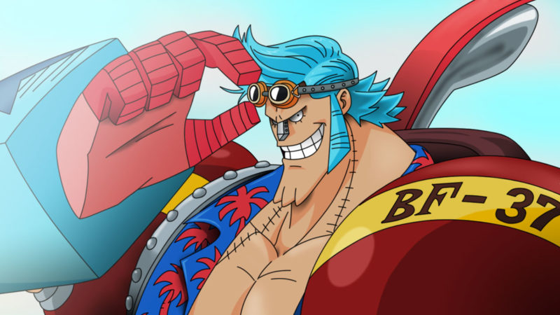 Franky, tem cabelos azuis, usando uma blusa havaiana, com um óculos na cabeça e seu braços e nariz são de ferro